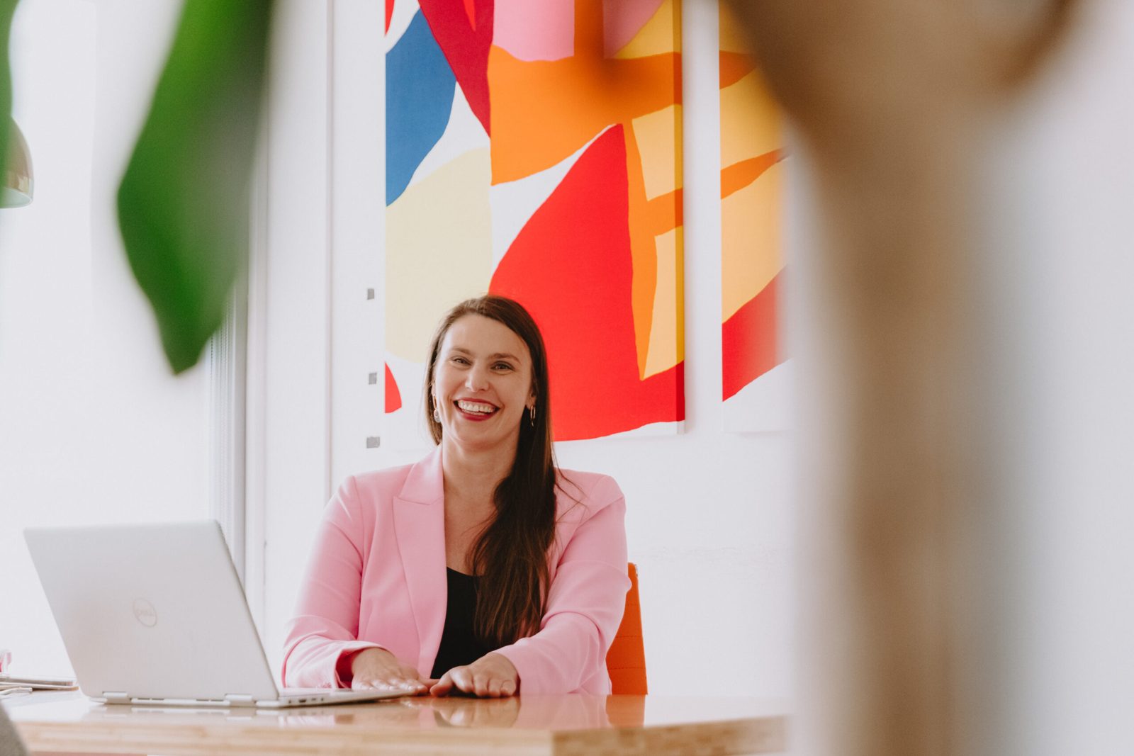Luiza Struska laughing at her desk in the ConnectLaw Gisborne office