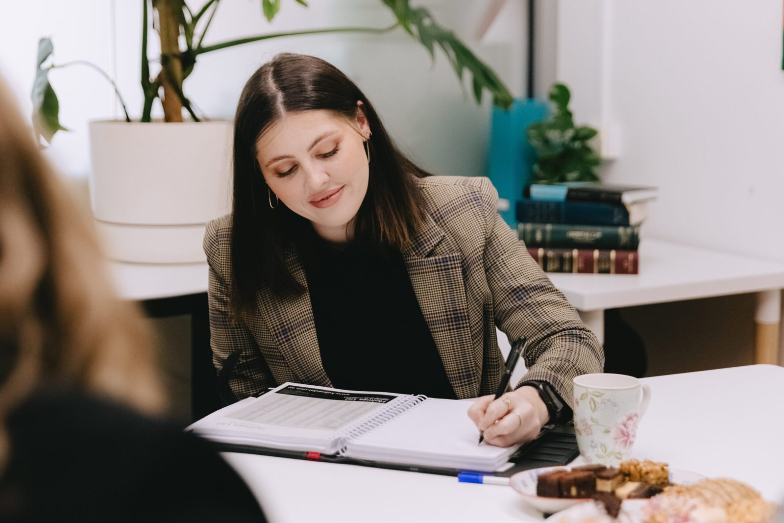 Luiza Struska meeting a client across the table